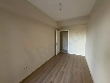 Bright bedroom view of a modern and spacious apartment.