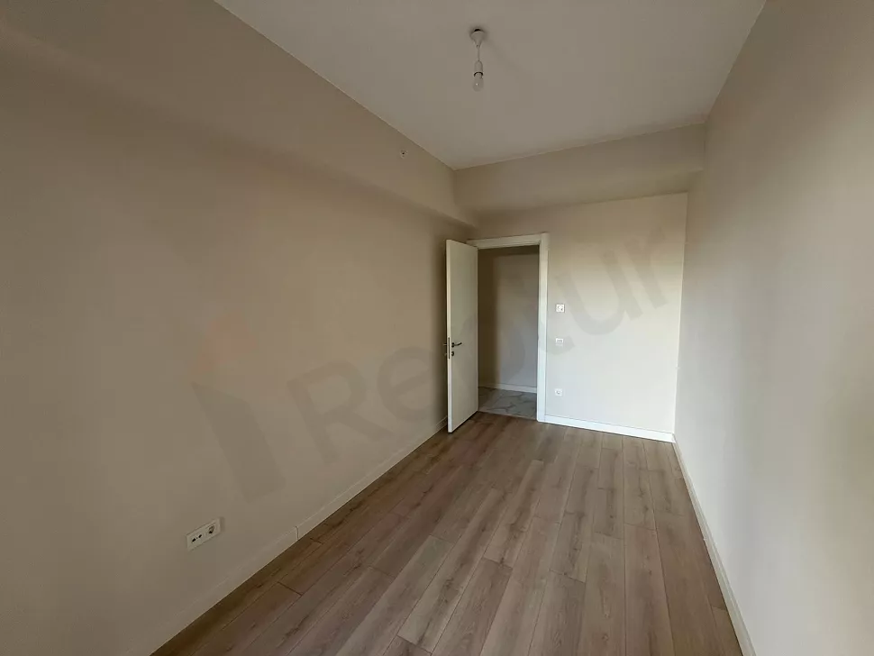 Bright bedroom view of a modern and spacious apartment.