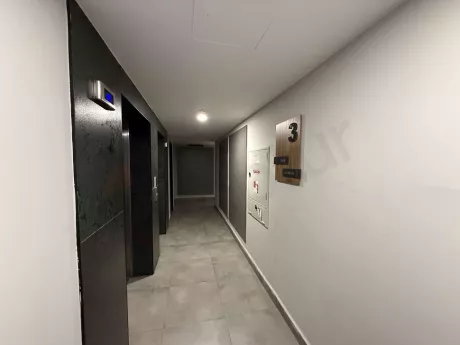 Modern elevator cabin with steel doors and stylish design in a building.