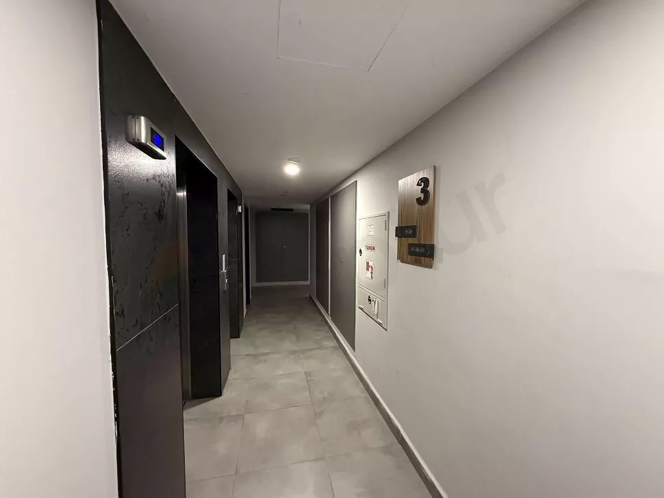 Modern elevator cabin with steel doors and stylish design in a building.