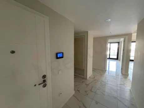 Entrance door and hallway area of an apartment in a modern building.