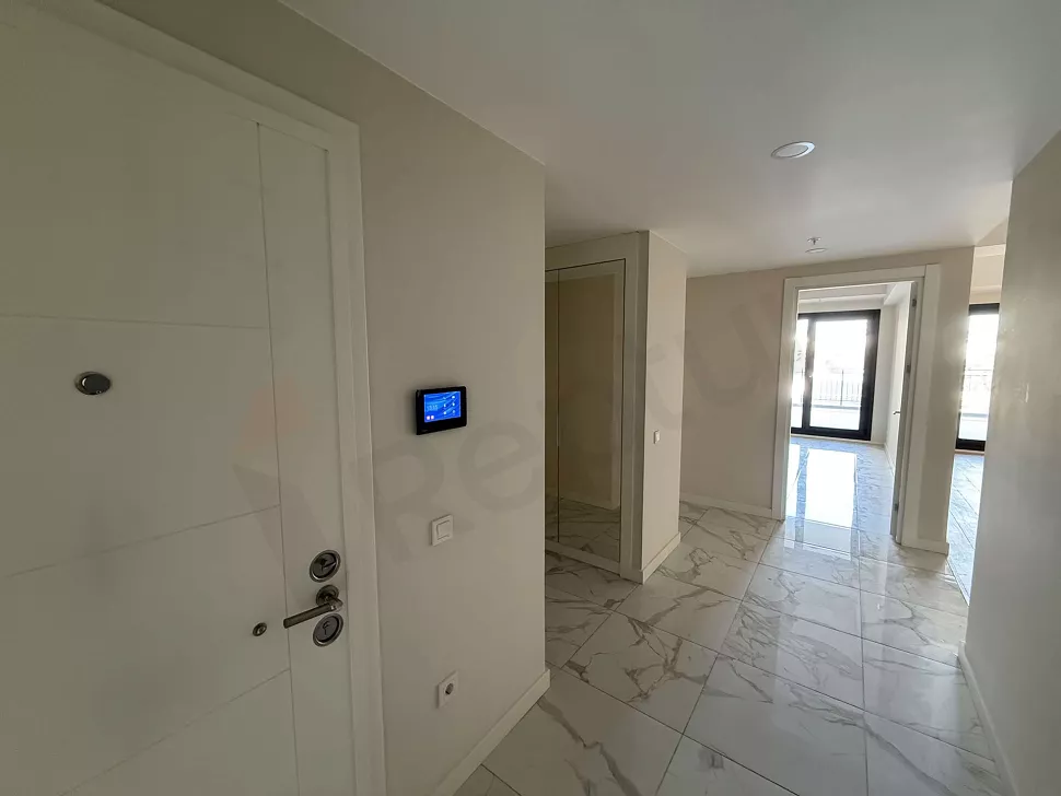 Entrance door and hallway area of an apartment in a modern building.