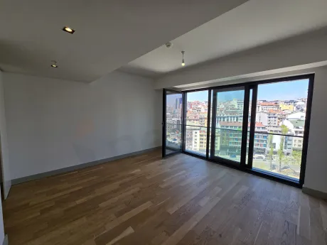 Modern and spacious living room area with large windows in a luxury project in Sisli.