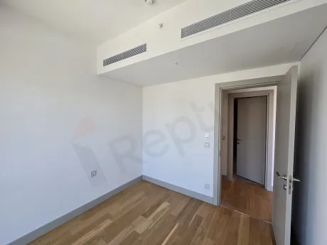 Modern and spacious bedroom interior with natural lighting.