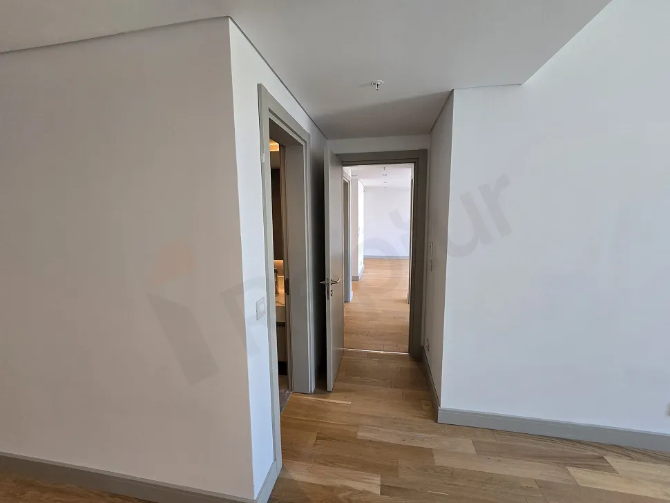 View of a spacious and bright apartment corridor in a modern building.