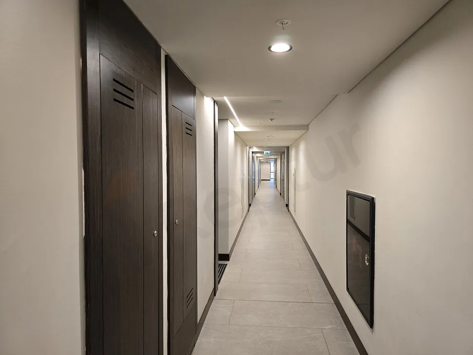 A bright and spacious apartment corridor in a modern and stylish building.