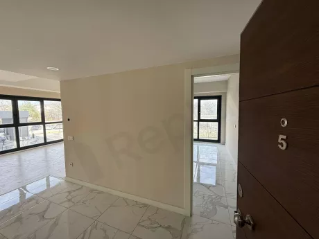 Entrance hall and foyer area of a modern designed apartment with a steel door.