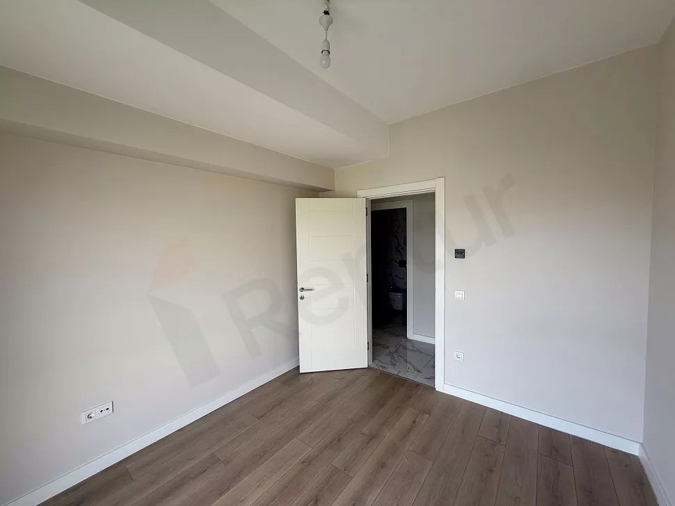 Spacious and bright modern bedroom interior view.