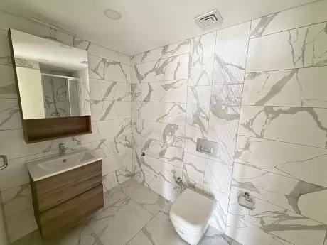 Modern bathroom design with spacious sink area and high-quality bathroom fixtures.