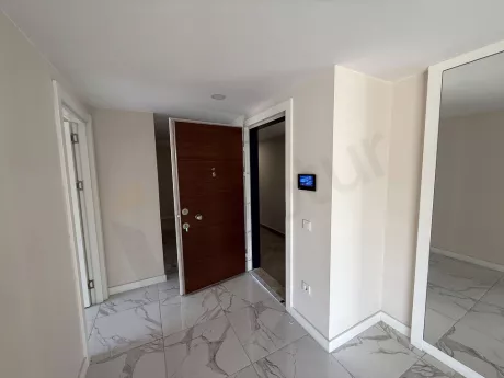 Spacious and modern entrance hall and foyer area of a flat.