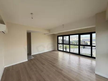 Spacious and modern living room area with natural light and contemporary architecture.