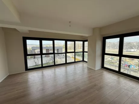 Spacious and bright empty living room of a 3+1 modern apartment in Cekmekoy, Istanbul.