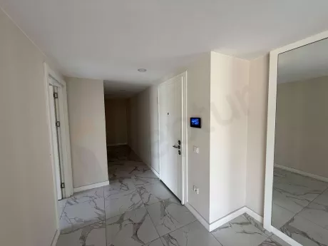 Entrance door and hallway area of a 3+1 apartment in a modern building.