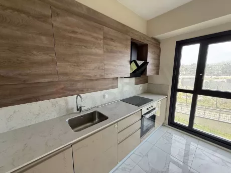 Modern and spacious kitchen design of an apartment in a new residential project.