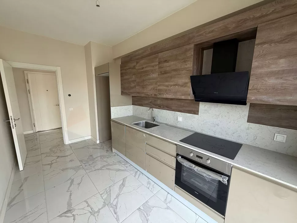 Modernly designed, spacious and bright apartment kitchen.