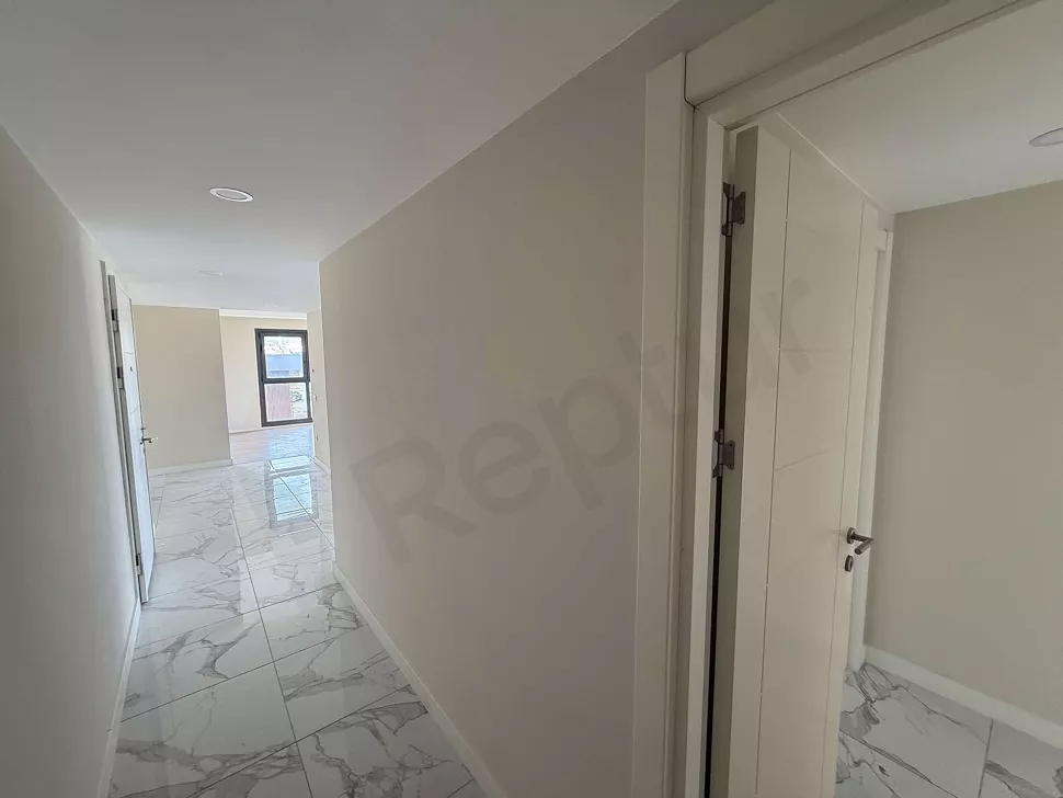 Spacious and bright corridor view inside a modern building.