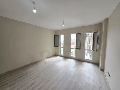 Bright and spacious living room area of a modern studio apartment.
