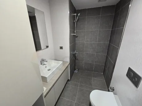 Modernly designed, stylish bathroom area with ceramic tiles.