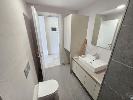 Modern bathroom interior with ceramic tiles and fixtures.