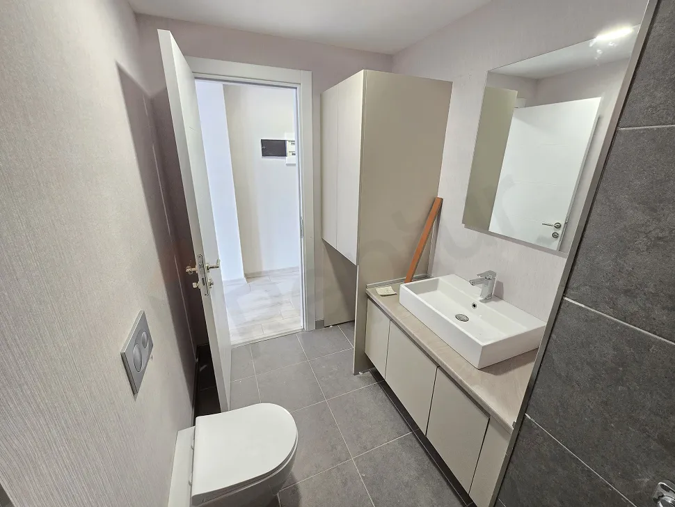 Modern bathroom interior with ceramic tiles and fixtures.
