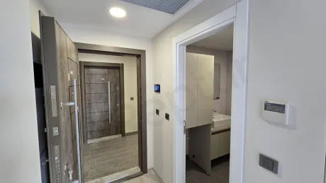 View of the entrance door and hallway area of a modern apartment.