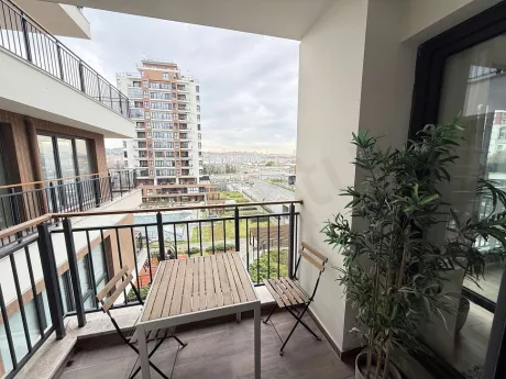 View of a spacious and bright balcony decorated with modern furniture.