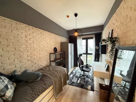 Spacious and bright bedroom interior with modern furniture.