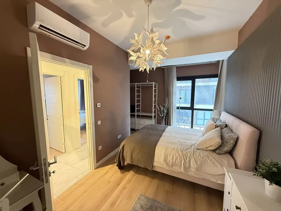 Interior view of a spacious and bright bedroom decorated with modern furniture.
