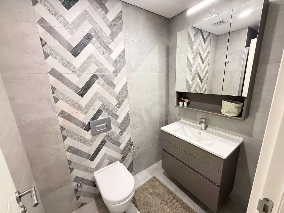 Interior view of a spacious and bright bathroom designed with modern fixtures and stylish finishes.