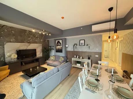 A bright and spacious living room visual decorated with a modern sofa set and furniture.