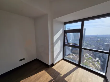Modern and bright bedroom interior with large windows.
