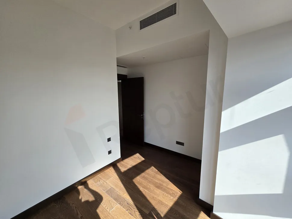 Interior view of a modern, spacious, and bright bedroom.