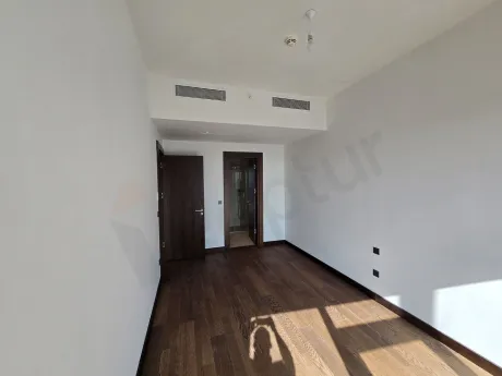 Modern designed bright bedroom with city view in a luxury residence in Sisli.