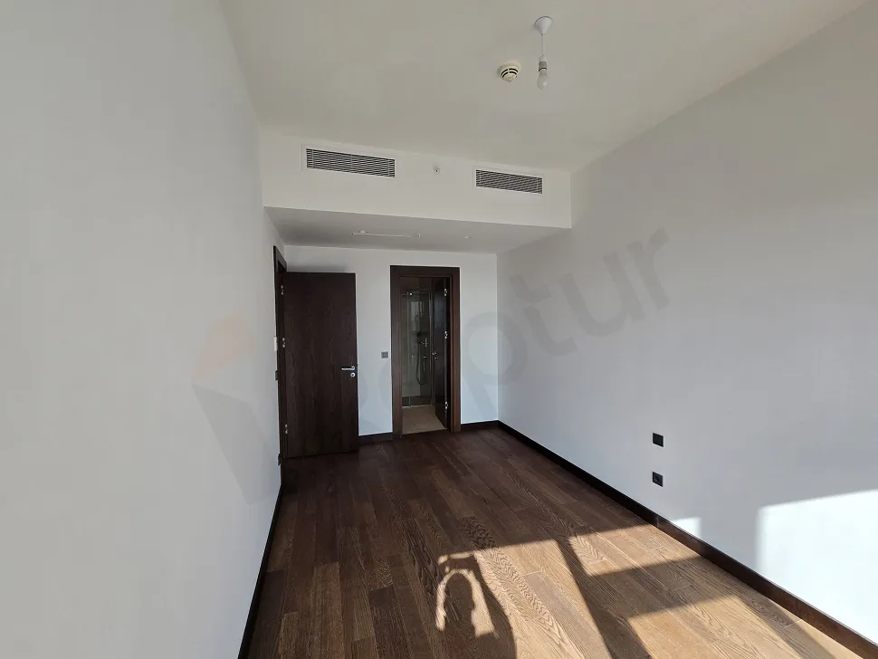 Modern designed bright bedroom with city view in a luxury residence in Sisli.