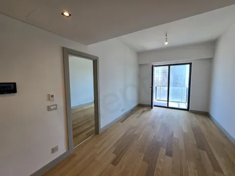 Spacious living room of a modern residence apartment in Sisli with large windows, city view, and natural light.