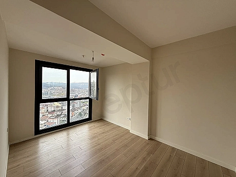 Modernly designed, bright bedroom view with large windows and natural light.