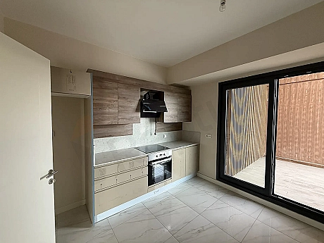 Modernly designed, spacious and bright kitchen area.