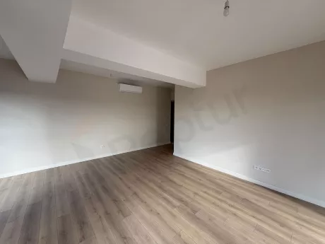 Spacious and bright living room area with modern architecture and large windows.