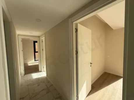 Spacious and bright hallway view of a newly built modern apartment.