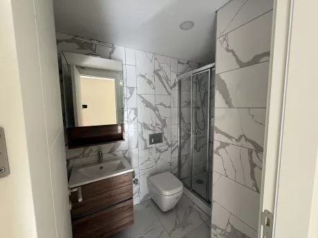 Modern designed, spacious and bright bathroom area.