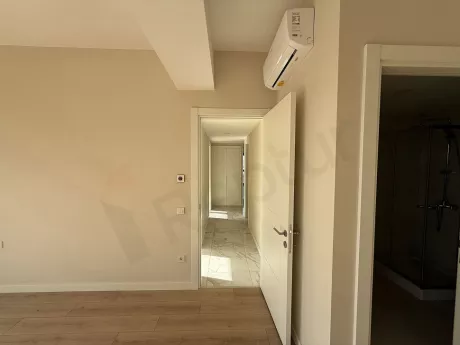 Bright corridor view of a modern and spacious apartment.