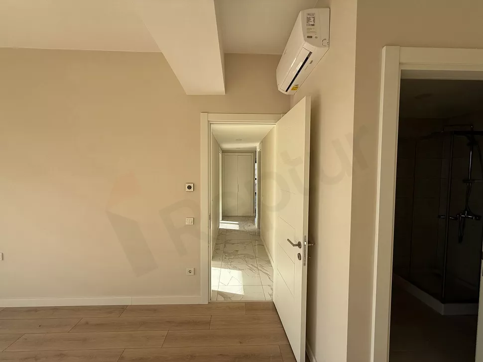 Bright corridor view of a modern and spacious apartment.