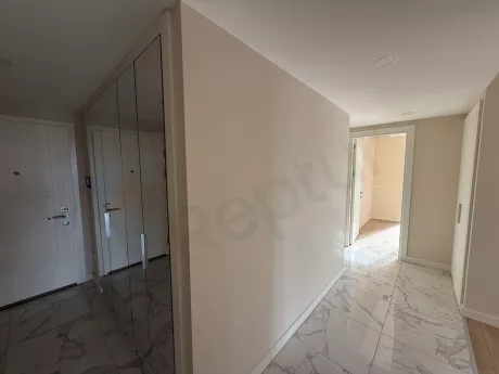 Entrance door and hallway area of an apartment in a modern building.