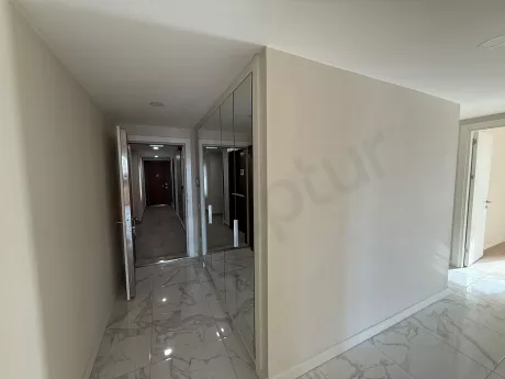 Interior view of the entrance door and hallway of a modern apartment.