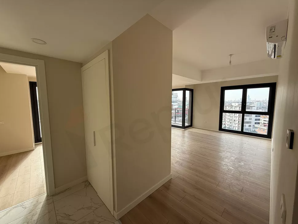 Spacious and modern living room interior of a bright apartment with natural light.