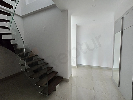 Interior view of a wooden staircase inside the apartment.