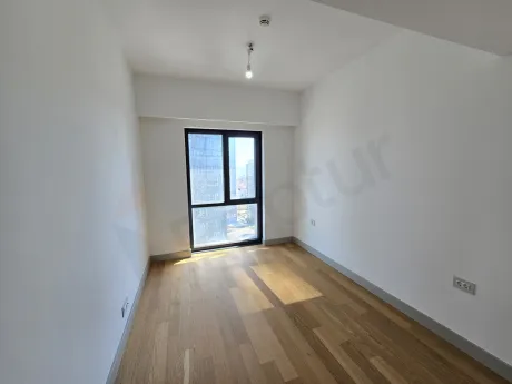 Image of a spacious and sunlit bedroom in a modern residence apartment.