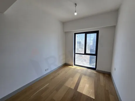 View of a bright, modern bedroom with large windows and stylish interior design.