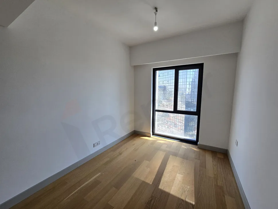 View of a bright, modern bedroom with large windows and stylish interior design.