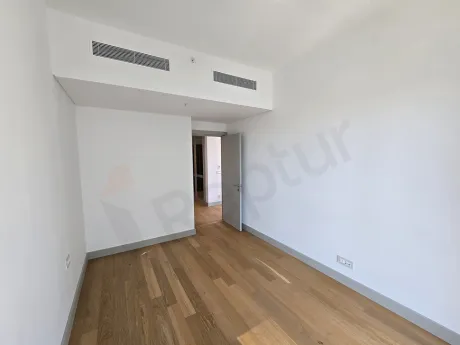 Spacious and bright empty bedroom of a modern residence apartment.